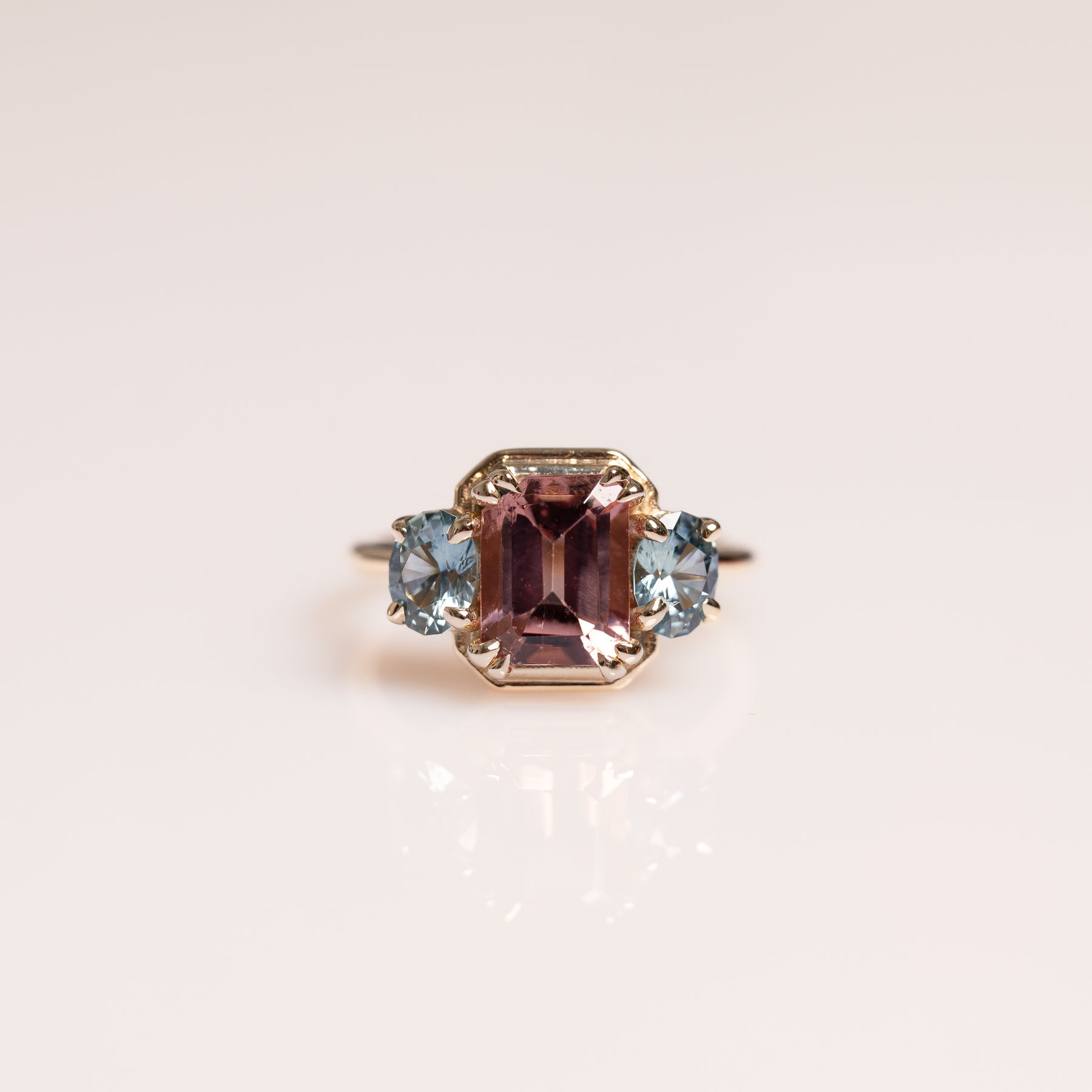 14k yellow gold emerald cut pink tourmaline, oval blue sapphire side stones ring 