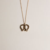 14k yellow gold pretzel pendant  necklace with diamond accent