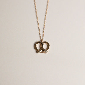 14k yellow gold pretzel pendant  necklace with diamond accent