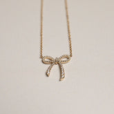 14k yellow gold diamond pave bow pendant necklace